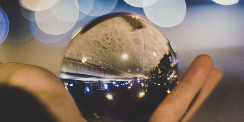 Man's hand grasping a crystal ball
